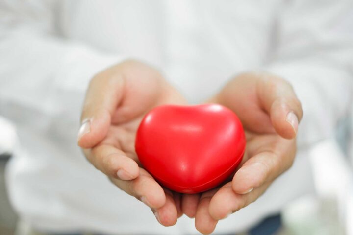 man-holding-red-heart-shaped-rubber-2023-11-27-05-14-36-utc